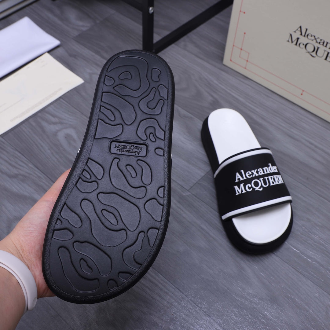 Black patterned rubber outsole with traction marks, with Alexander McQueen slide