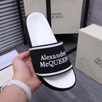 Textured white footbed and black slide strap with Alexander McQueen logo