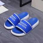 Blue slide sandals with white stripe straps and Alexander McQUEEN logo