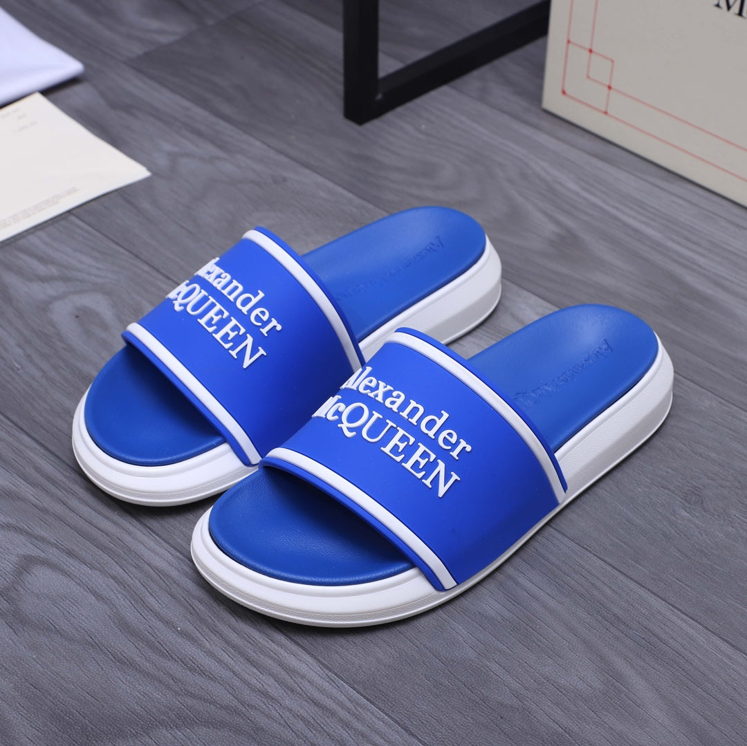 Blue slide sandals with white stripe straps and Alexander McQUEEN logo