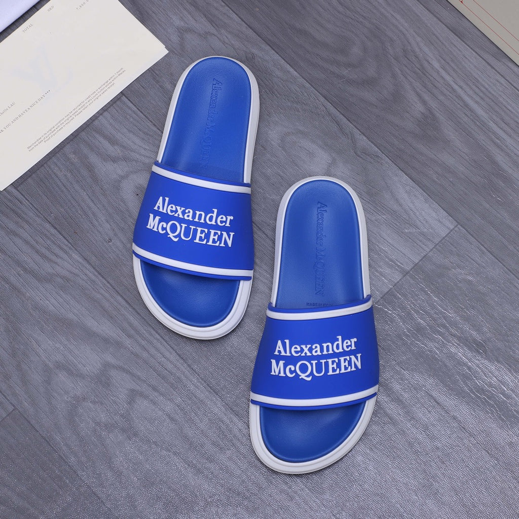 Pair of blue slide sandals with white trim and Alexander McQUEEN branding