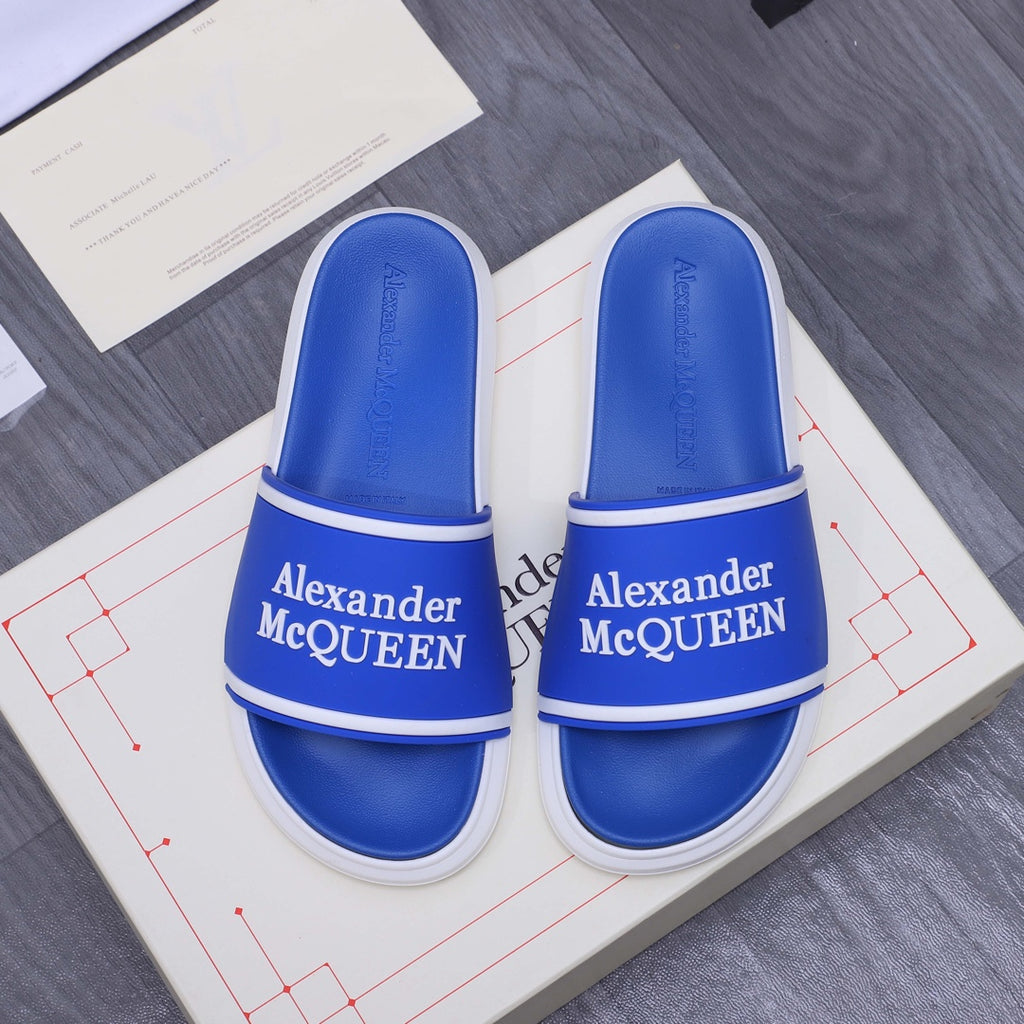 Blue slide sandals with white trim and Alexander McQUEEN logo on straps