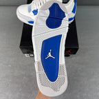 White sneaker sole with blue heel panel and Jordan logo on blue, grippy tread.