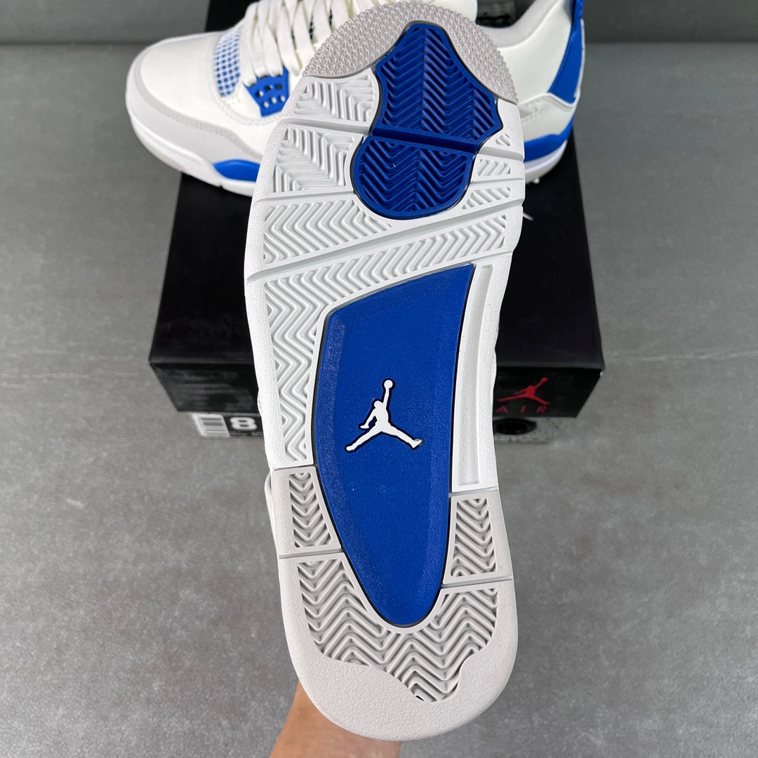 White sneaker sole with blue heel panel and Jordan logo on blue, grippy tread.
