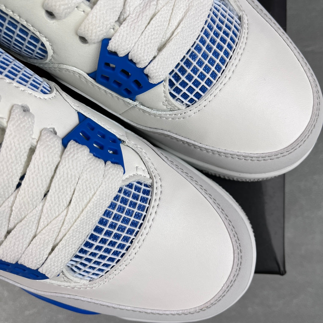 White sneakers with blue mesh overlays and blue lace tabs, close-up of uppers.