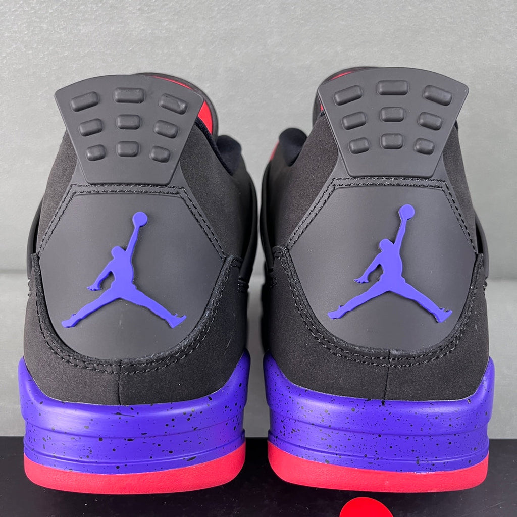 Air Jordan 4 sneakers back view with purple midsole and red-accent heel tabs