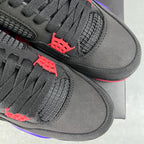 Pair of black Air Jordan 4 sneakers with textured net panels and red accent tabs