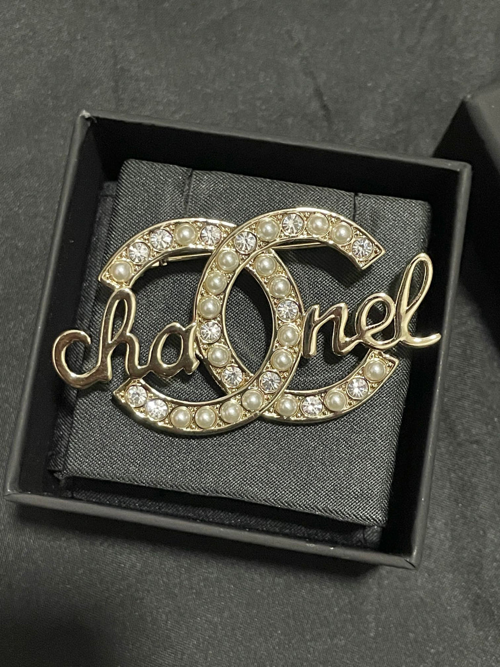 Gold-tone Chanel brooch with pearl and crystal accents, open O script motif