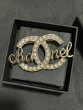 Gold-tone Chanel brooch with pearl and crystal accents, open O script motif