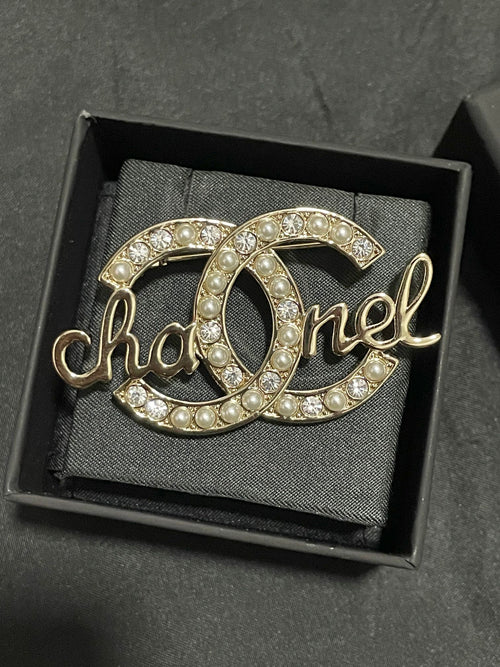 Gold-tone Chanel brooch with pearl and crystal accents, open O script motif