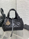 Quilted black Dior handbag with top handles and gold-tone logo charm