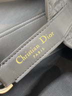 Gray leather Dior strap label with gold 'Christian Dior Paris' text