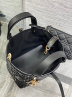 Black Dior bucket-style handbag with side handles and detachable strap