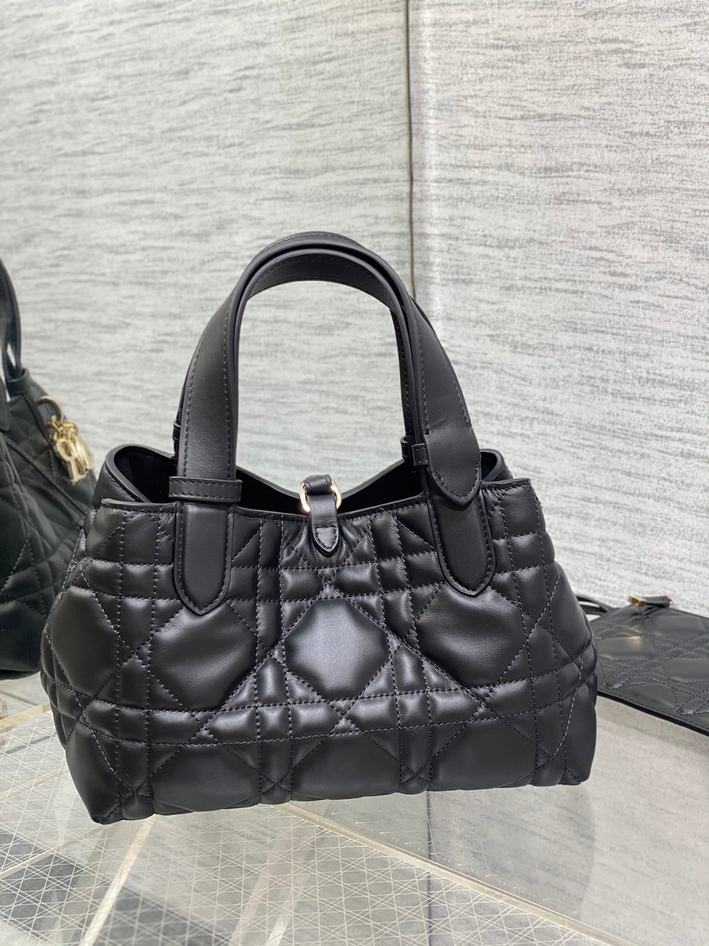 Quilted black Dior mini tote with top handle and metal clasp