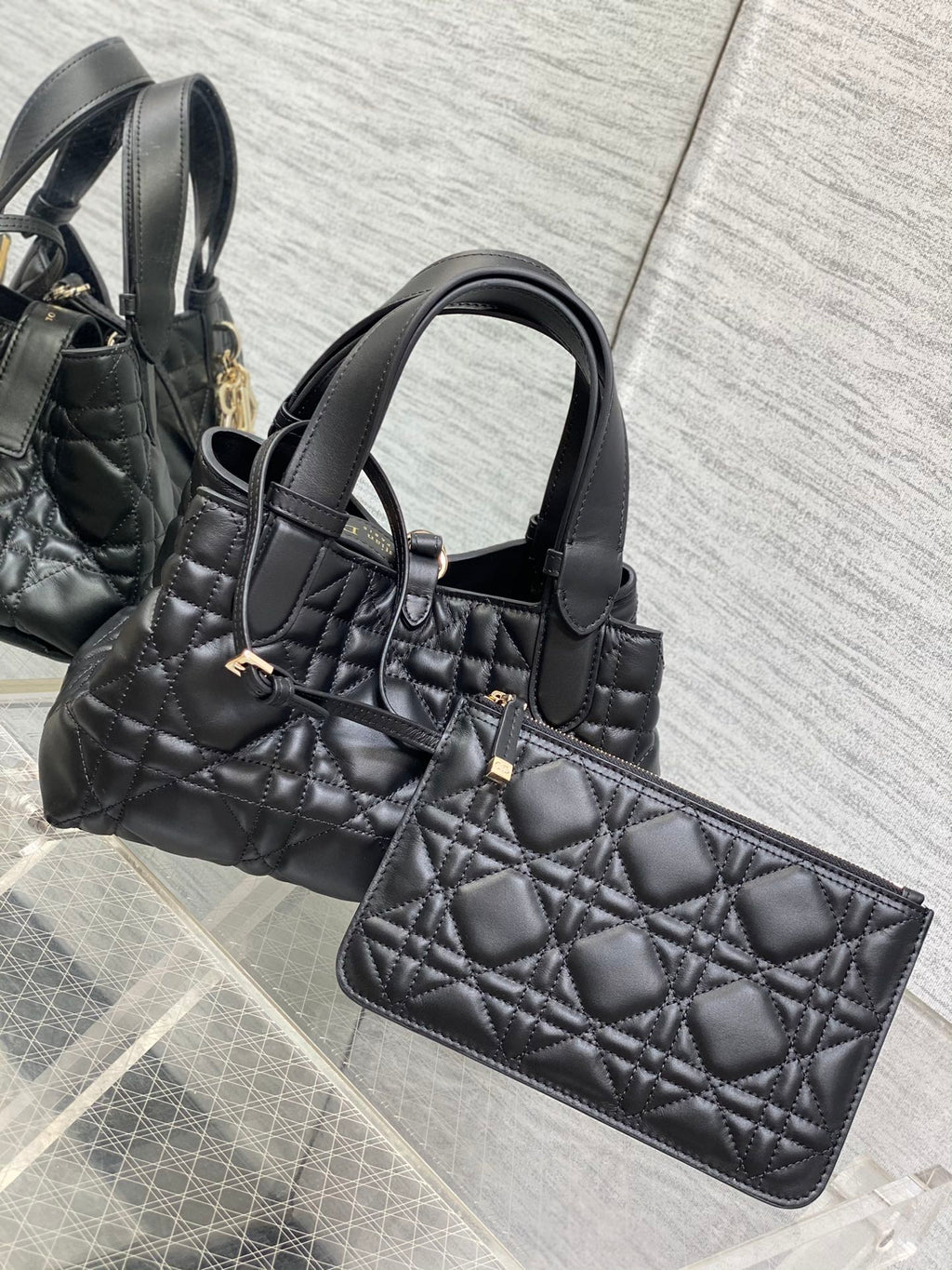 Black quilted Dior handbag with matching wallet pouch on strap