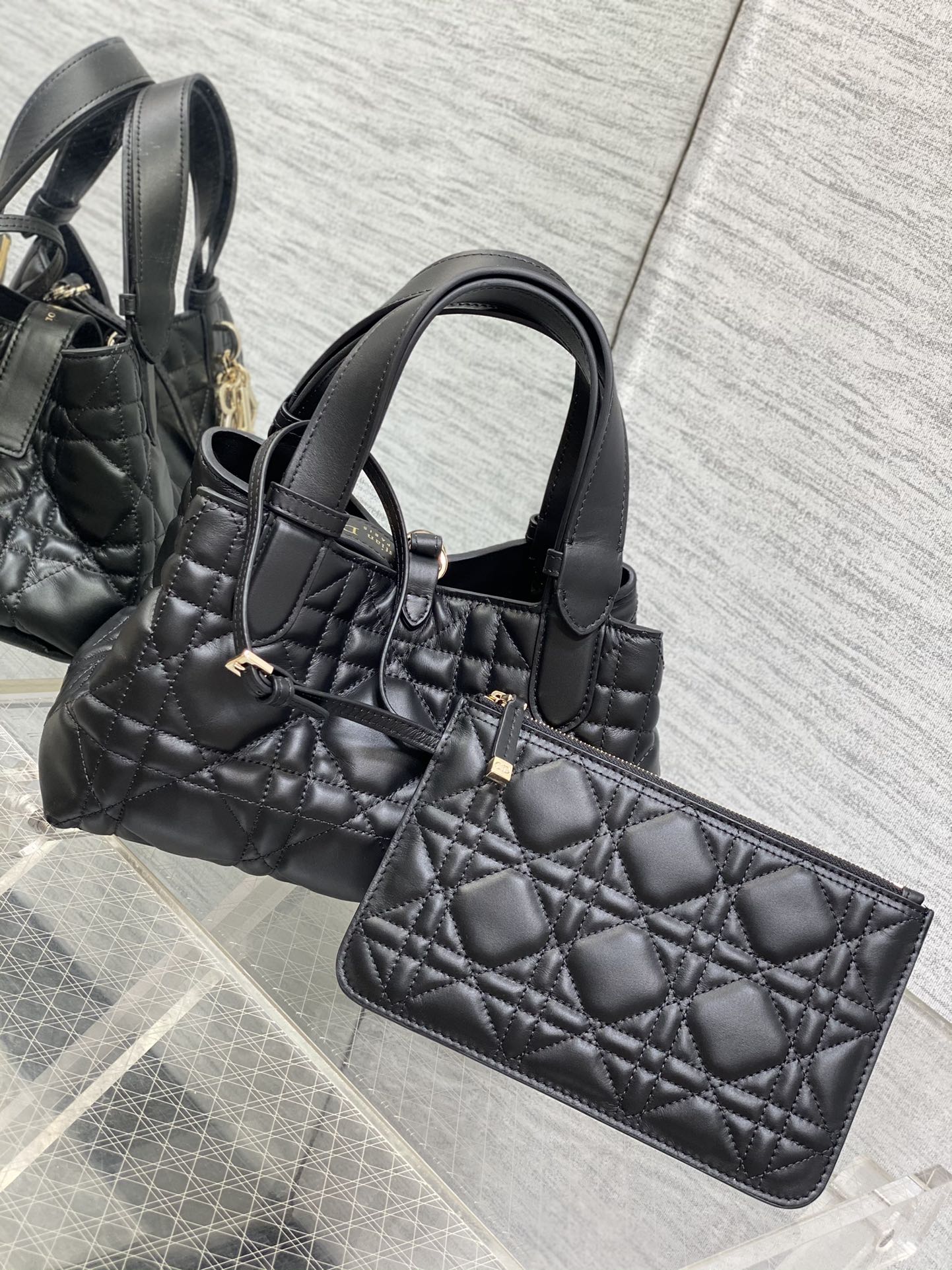 Black quilted Dior handbag with matching wallet pouch on strap