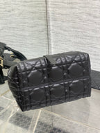 Quilted black Dior bag with structured top and horizontal zipper panel