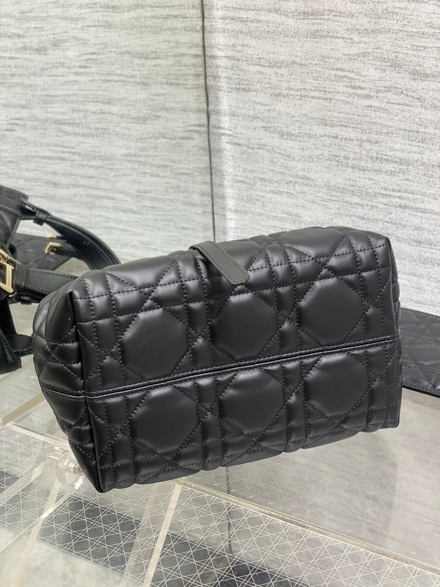 Quilted black Dior bag with structured top and horizontal zipper panel