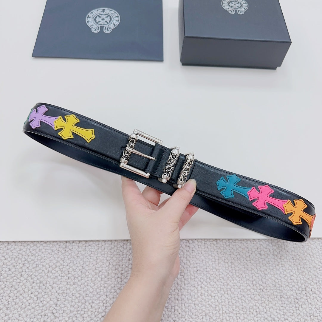 Chrome belt on hand: dark blue strap with colorful star pattern and silver rectangular buckle