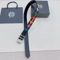 Chrome belt with dark blue strap, rainbow star appliques, silver buckle and chain detail