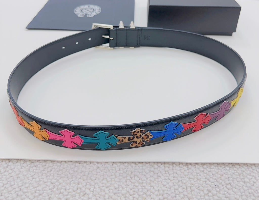 Chrome belt flat lay: dark blue strap with colorful star appliques and silver buckle hardware