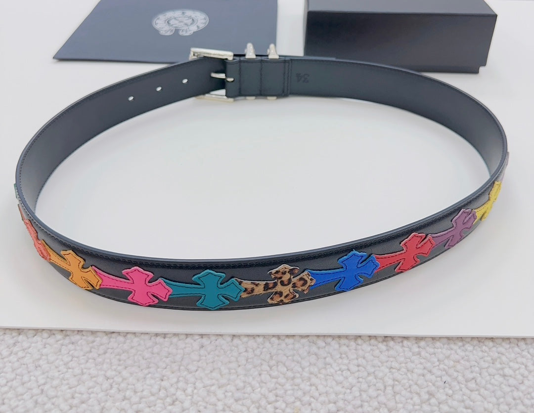 Chrome belt flat lay: dark blue strap with colorful star appliques and silver buckle hardware