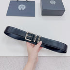 Dark leather belt with silver buckle and decorative metal accents, strap laid out