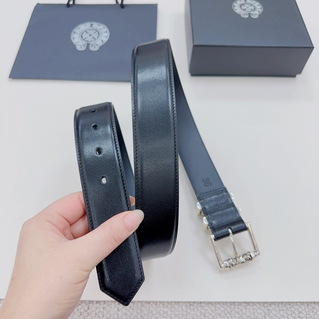 Dark leather belt with stitched edges and silver buckle backing, folded view