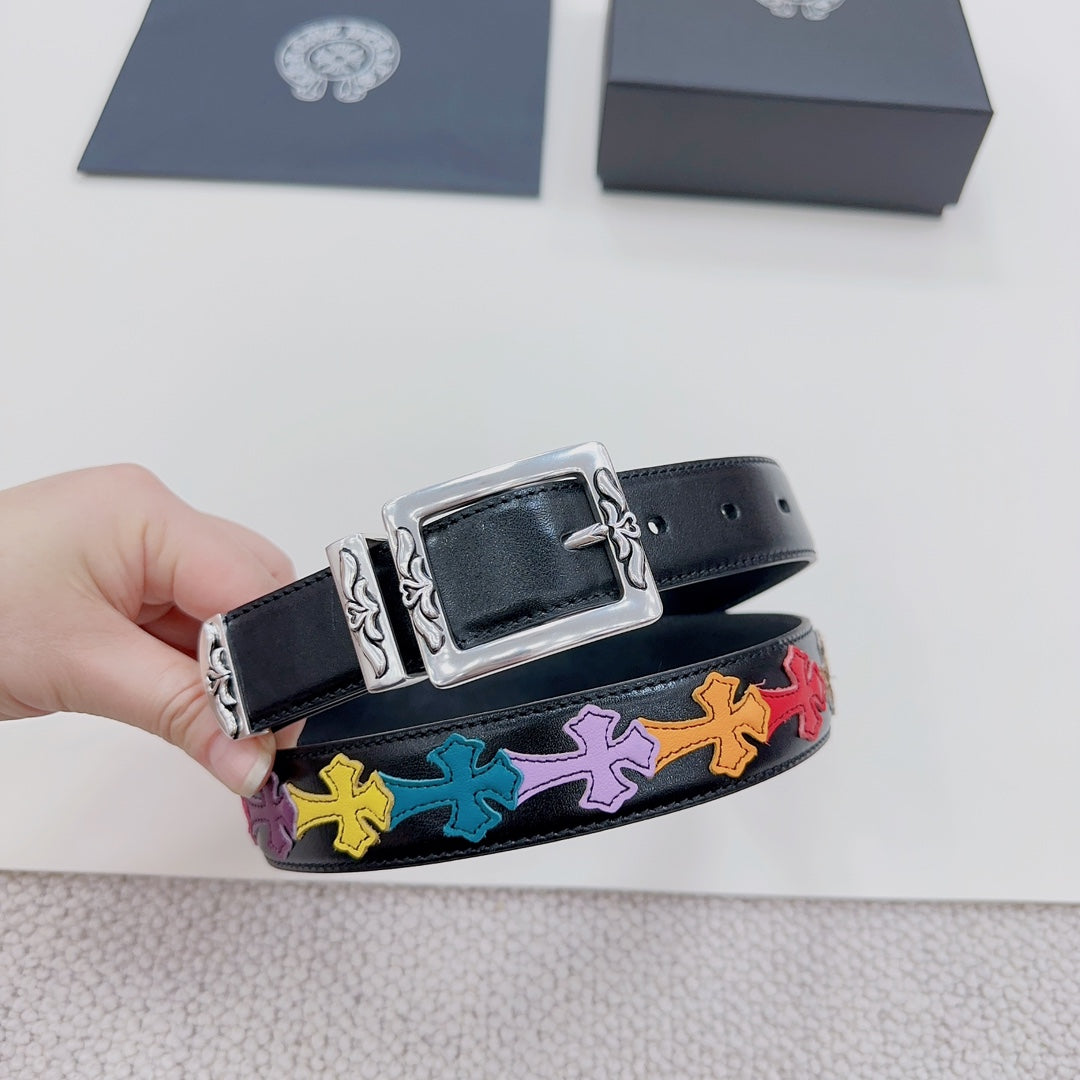 Dark blue belt detail with silver buckle and multicolor cross pattern near the holes