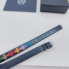 Dark blue belt with multicolor cross trim and silver buckle underside view