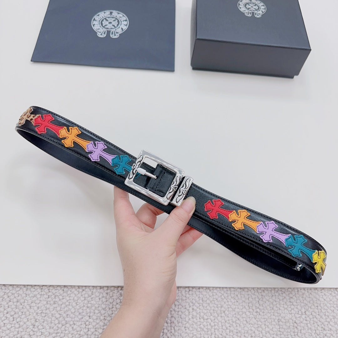 Dark blue belt laid flat, colorful cross trim across the strap and silver buckle