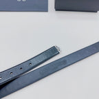 Dark blue belt strap with perforation holes and embossed logo on the inside