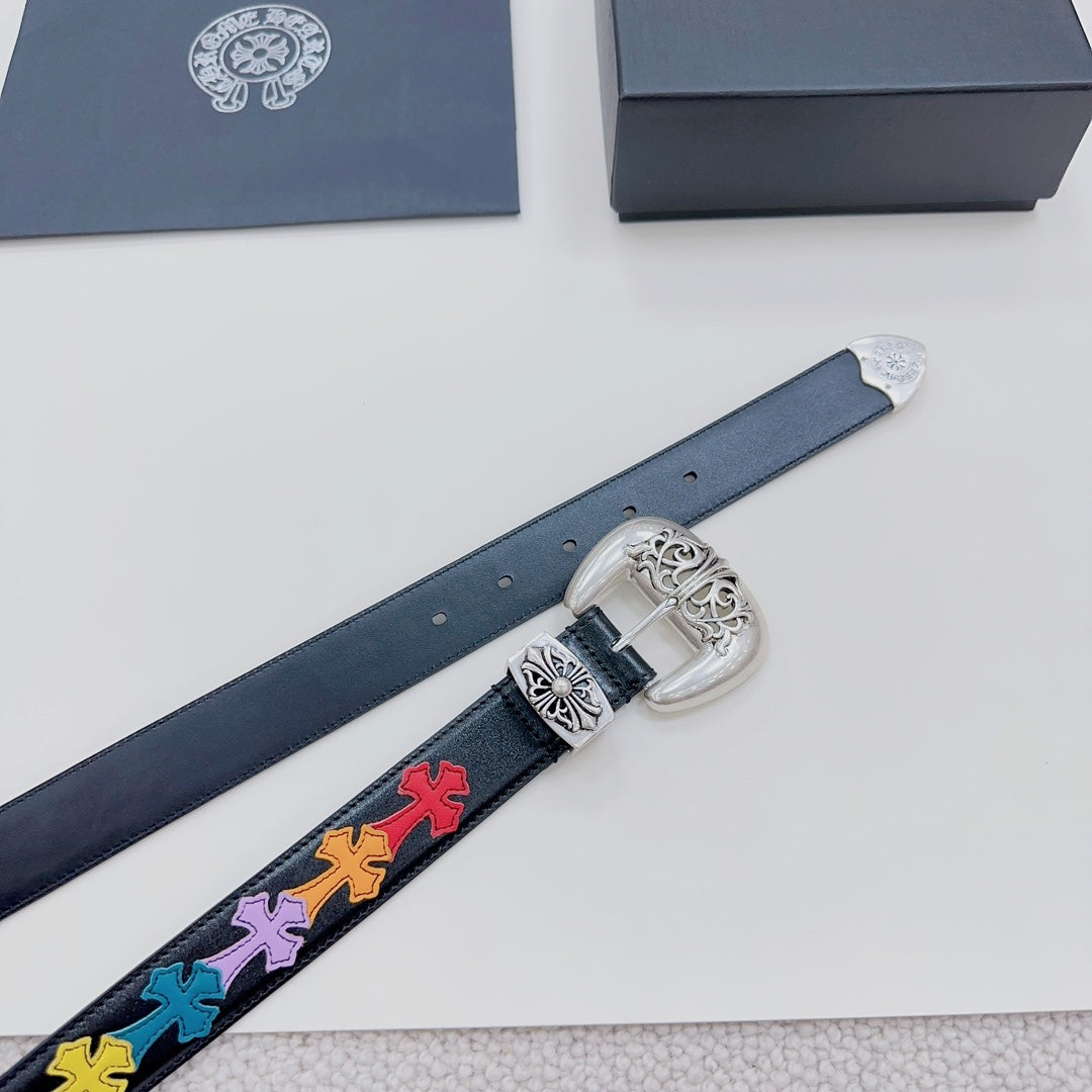 Dark blue leather belt detail with silver buckle and multicolor cross-pattern strip on strap.