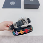 Dark blue leather belt with silver buckle set and multicolor cross-pattern strap detail.