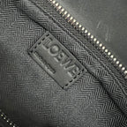 Black patterned lining with LOEWE brand label near zipper edge.