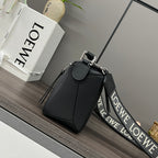 Black leather top-handle bag with flap closure, silver buckle, and strap.
