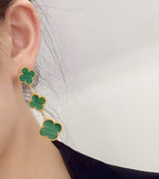 Clover ear climber earrings with green enamel and gold-tone links, worn on ear