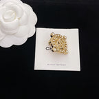 Gold-tone rhinestone Chanel brooch, shield-shaped frame with dangling stones