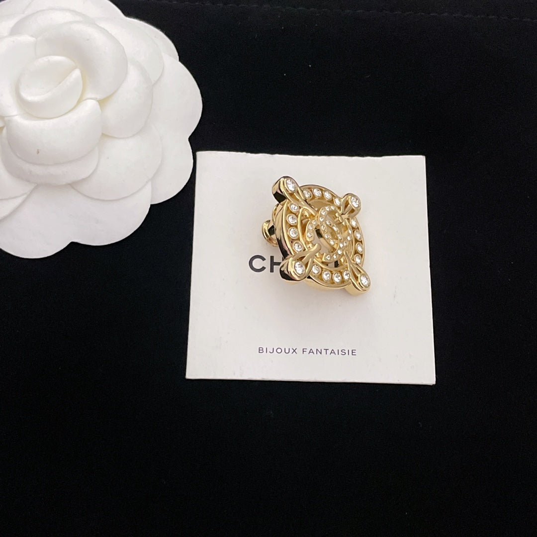 Gold-tone rhinestone Chanel brooch, shield-shaped frame with dangling stones