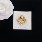 Gold-tone rhinestone Chanel brooch, domed center with starburst bezel
