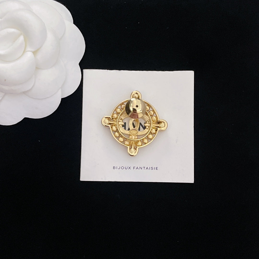 Gold-tone rhinestone Chanel brooch, domed center with starburst bezel