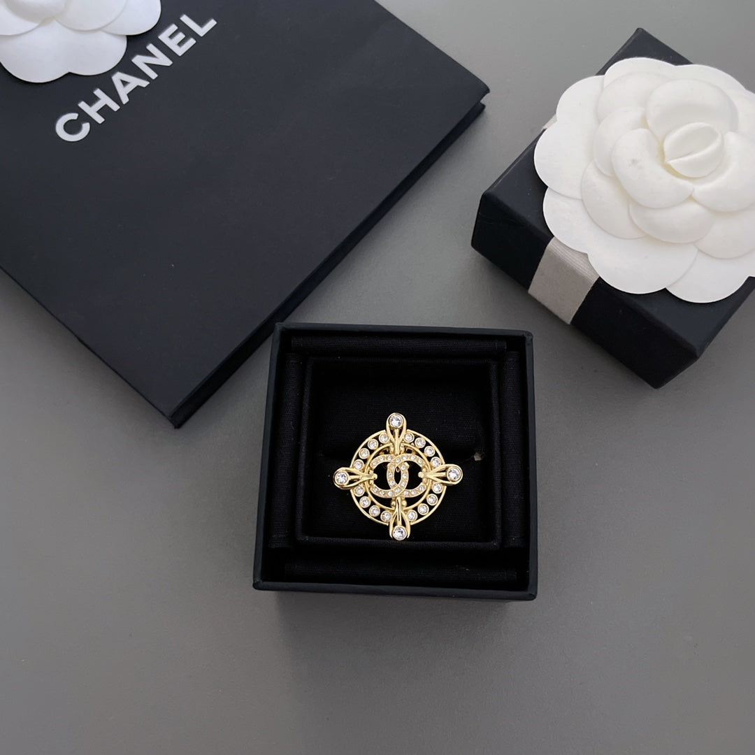 Gold-tone rhinestone Chanel brooch in black display box