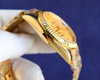 Rolex watch side profile with gold-tone case and ridged bezel on metal bracelet