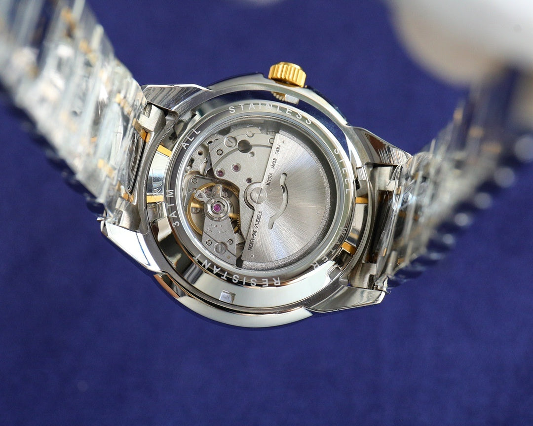 Rolex watch open caseback with visible movement and gold crown