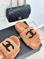 Tan teddy slide sandals with black beaded CC logo; CHANEL label on insole