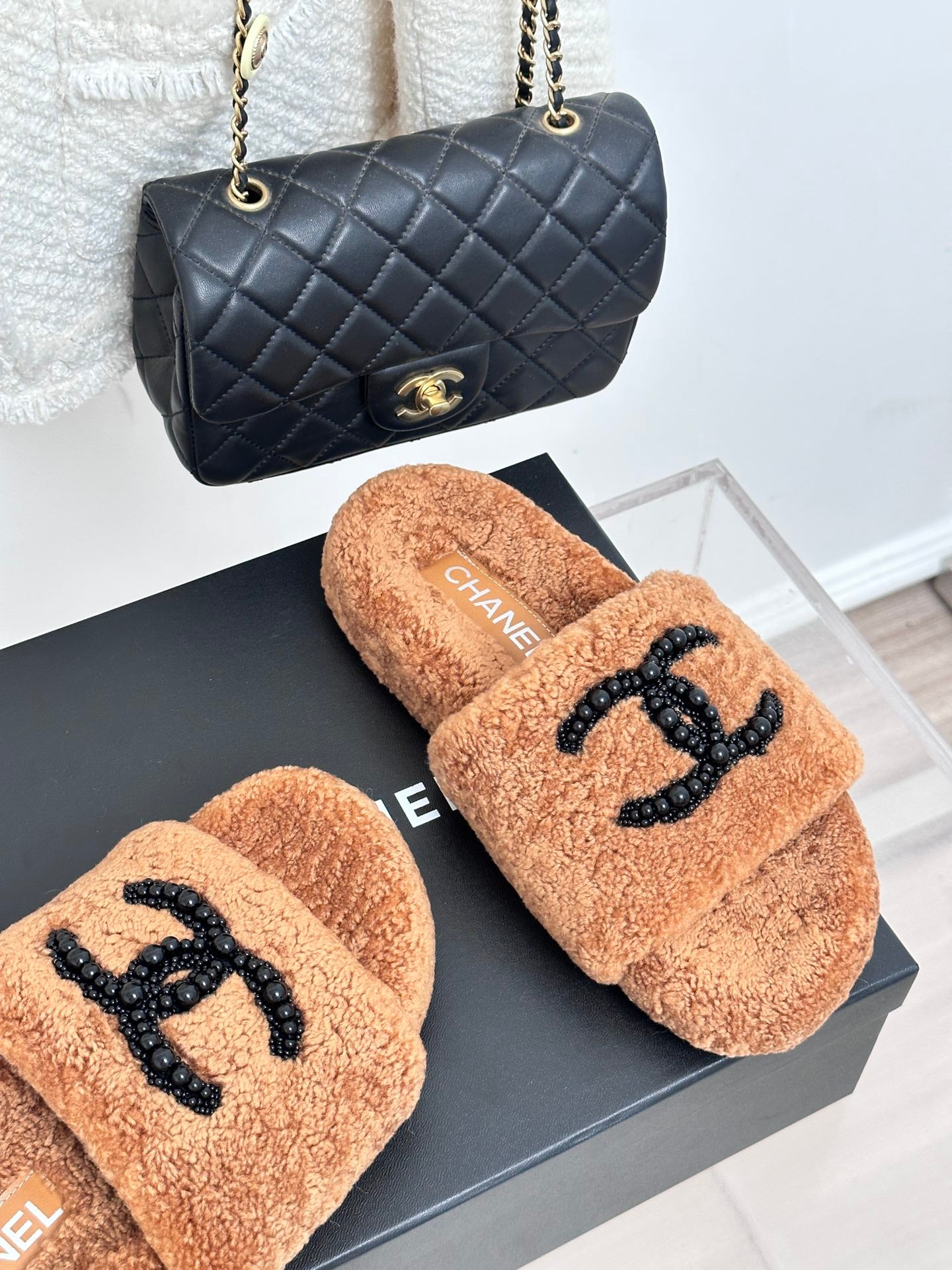 Tan teddy slide sandals with black beaded CC logo; CHANEL label on insole