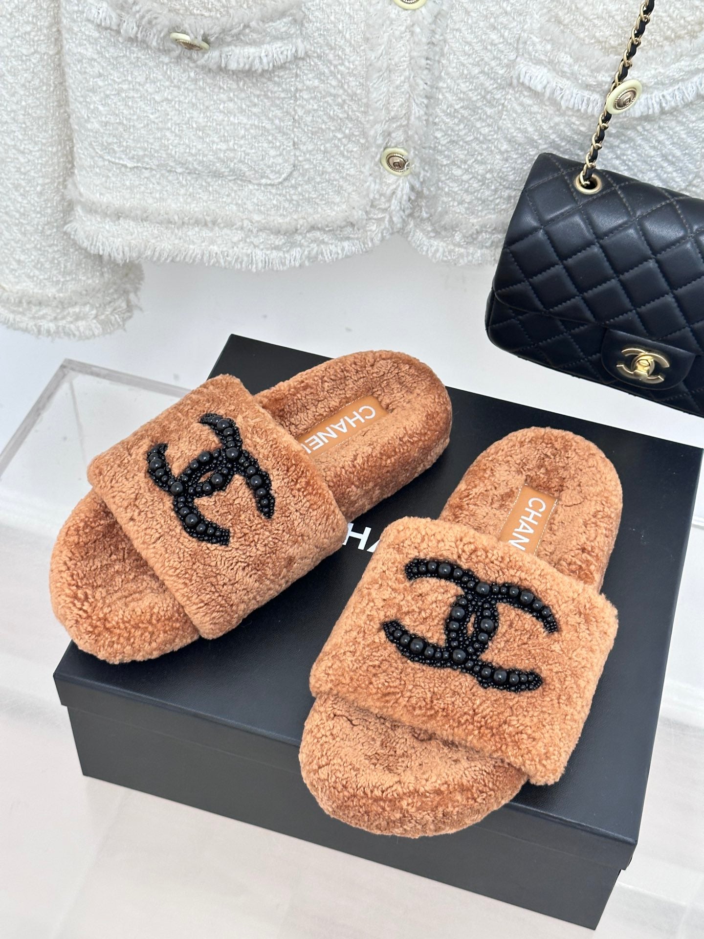 Brown teddy slide sandals with black beaded CC logo; CHANEL on insole