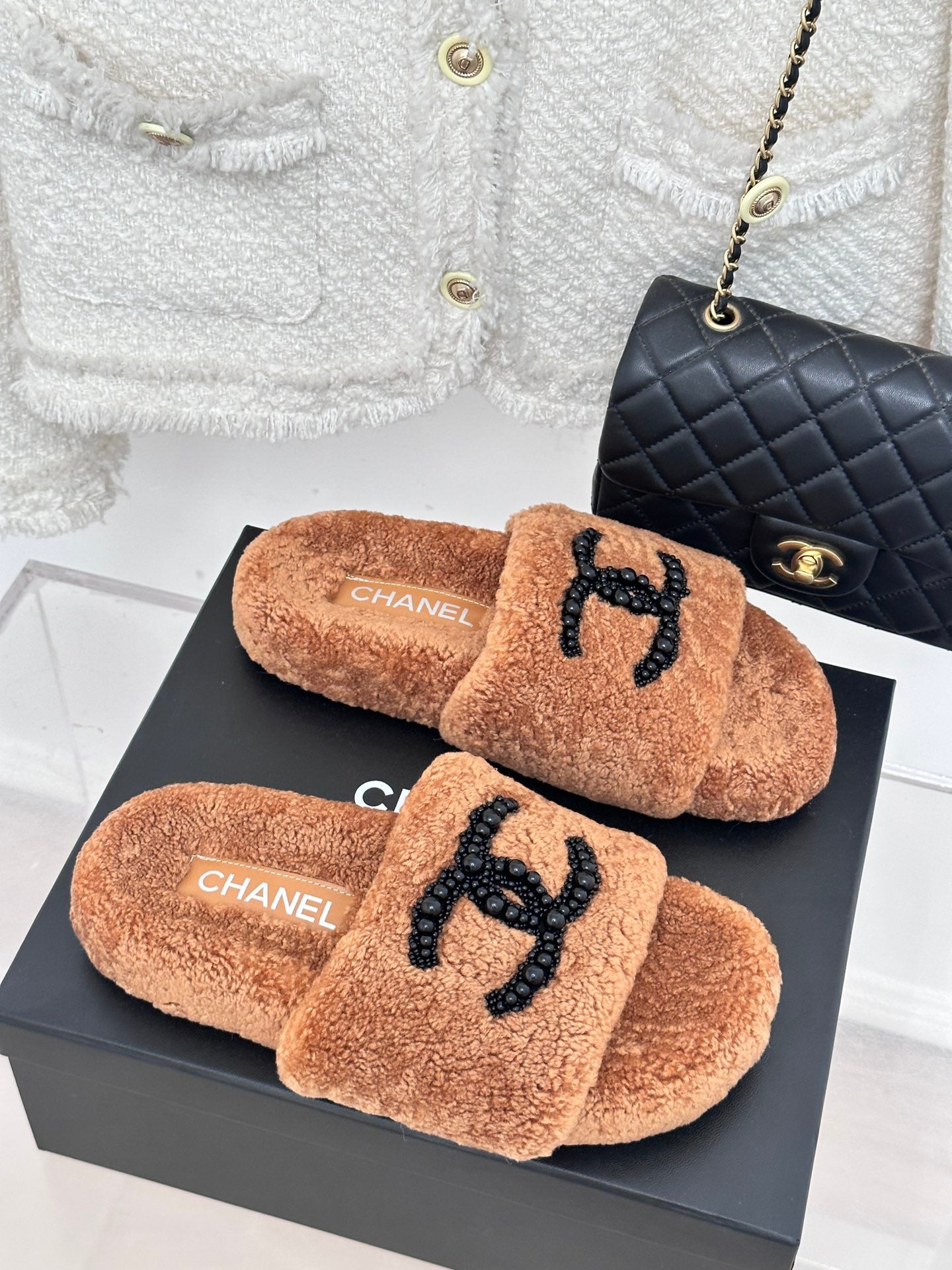 Brown teddy slide sandals with black beaded CC logo and CHANEL branding