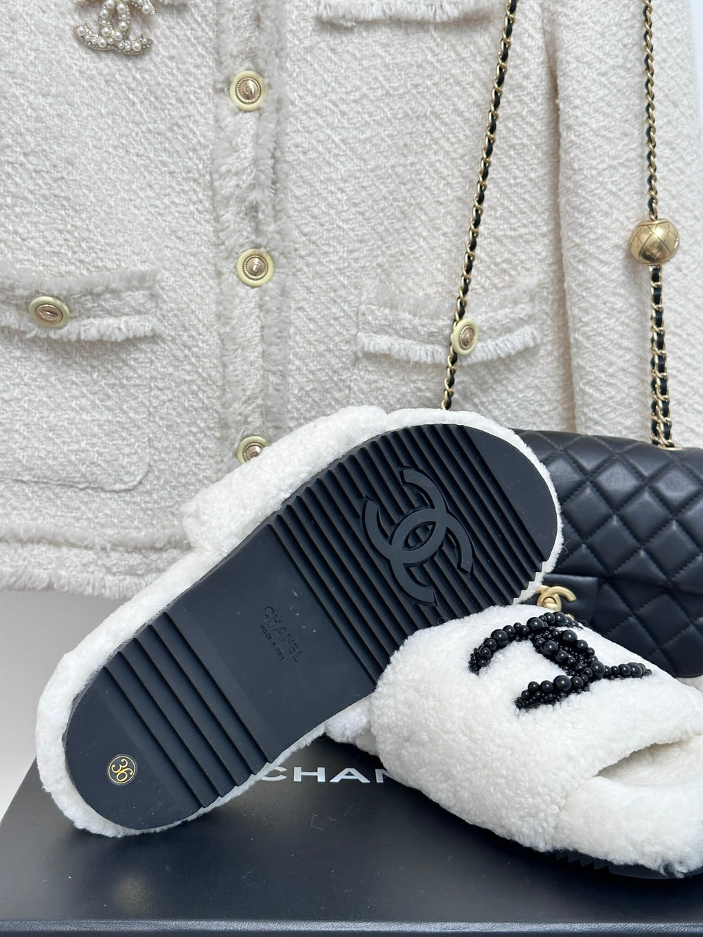 Chanel white fuzzy slides with black CC emblem, outsole and top view