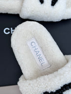 Chanel white fuzzy slides with brand label patch and black CC emblem
